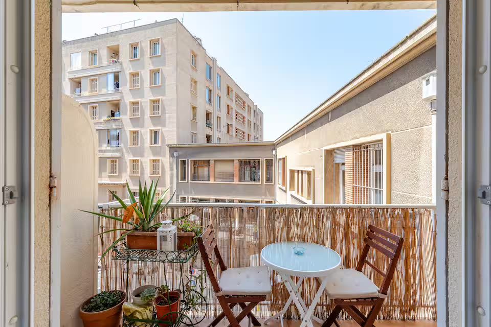 SoleaStay Marseille — balcony with bistro table and Marseille rooftop view