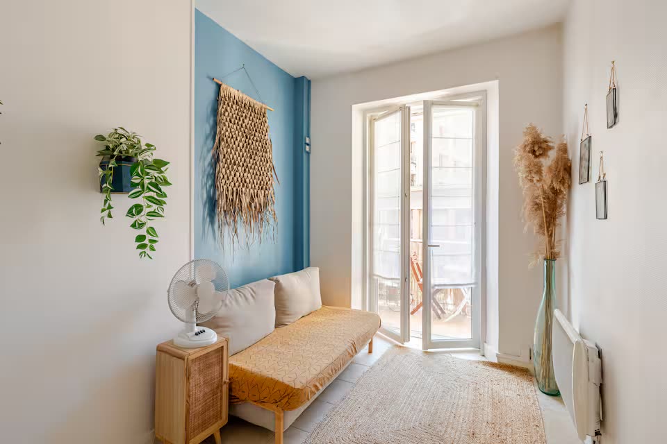 SoleaStay Marseille — living room with blue accent wall and balcony light